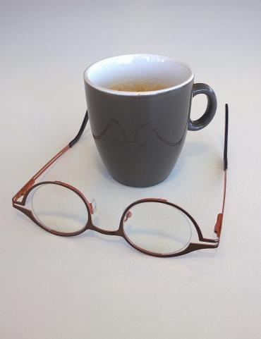Logo luistermagazine Zienswijs: bril ondersteboven voor koffiebeker